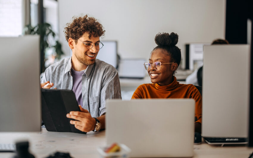 Two young colleagues working together at modern office