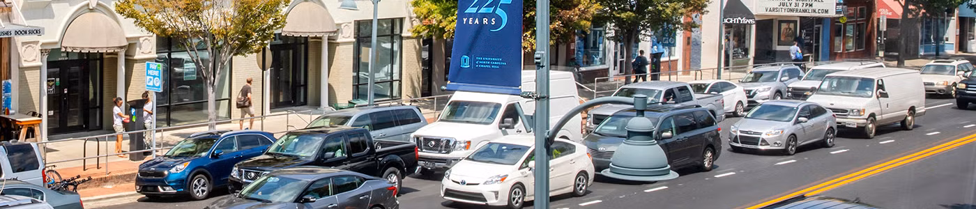 cars driving a downtown street in one direction