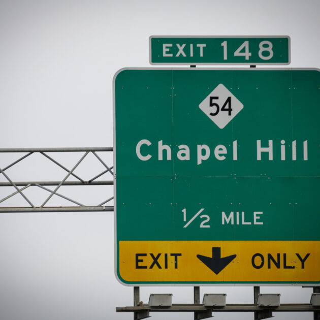 A highway sign leads to the way to Chapel Hill, NC, USA.